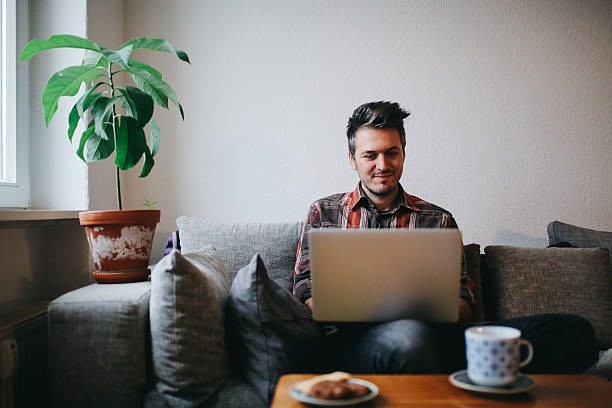 istock Young man doing a freelance job from home 637927770