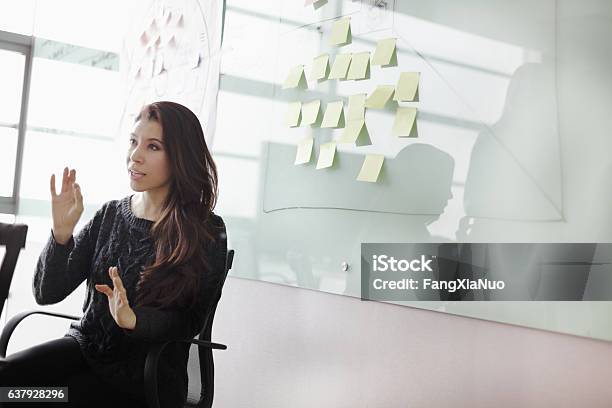 Woman Discussing Ideas And Strategy In Studio Office Stock Photo - Download Image Now