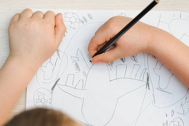 istock young kid painted of abstract picture 637928464