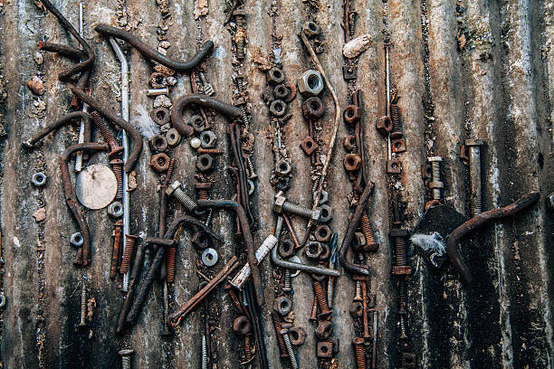 Stack of rusty and old screws on metal background