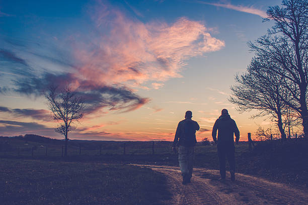 Silhouette of two man looking at the view  from their hiking trail