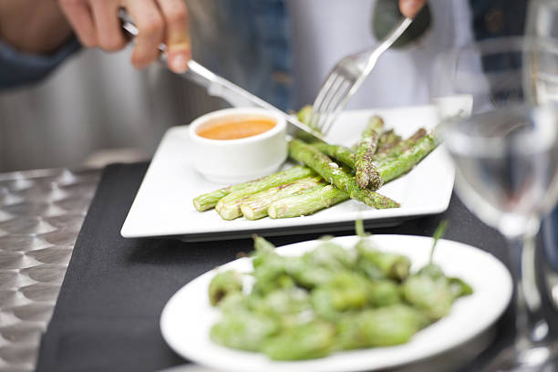 Eating asparagus Unrecognizable woman eating healthy asparagus eating asparagus stock pictures, royalty-free photos & images