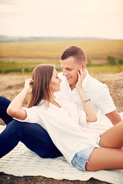 istock Happy couple holding hands and walking together outdoors at sunset 637933862