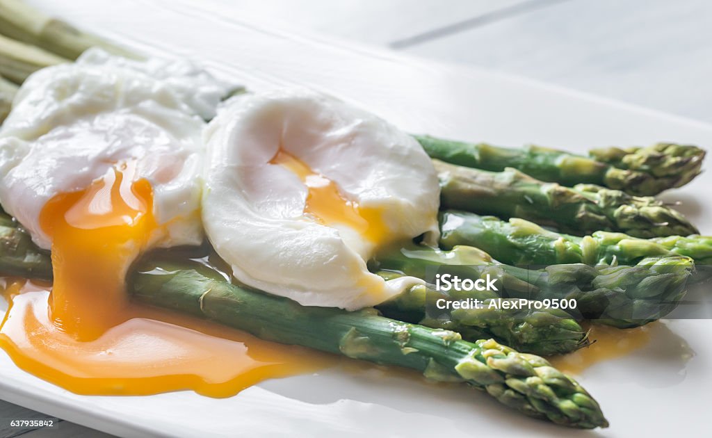 Steamed asparagus with poached eggs Steamed asparagus with poached eggs on the plate Egg - Food Stock Photo