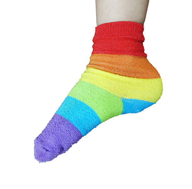istock wearing Rainbow sock on feet isolated on white. 637939086