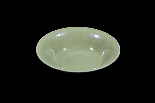 istock Soup green plate on black background from side 637939324