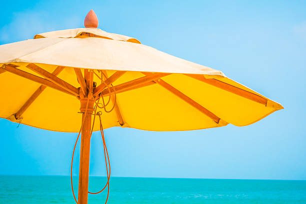 istock Yellow parasol on the beach 637940460