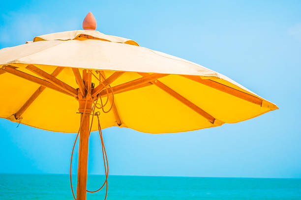 istock Yellow parasol on the beach 637940494