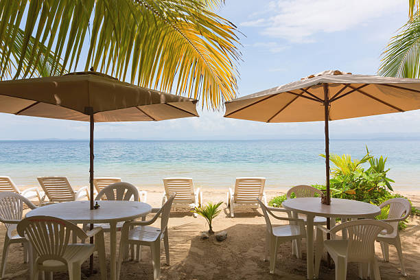 istock Restaurant tables and sun lounger on the beach 637940970