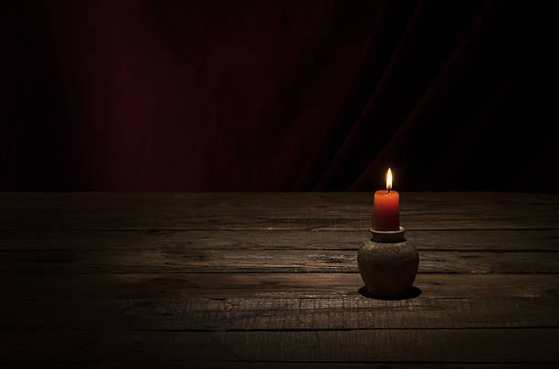 istock Candle on wooden table. 637944238