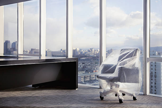 istock New desk chair wrapped with bubble pack in executive office 637945662