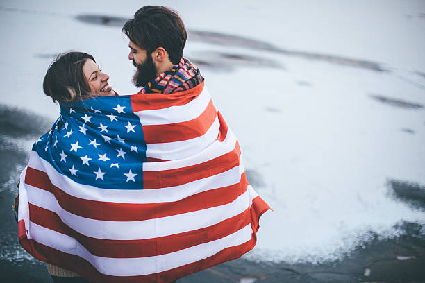 istock Couple looking each other under American flag 637946536