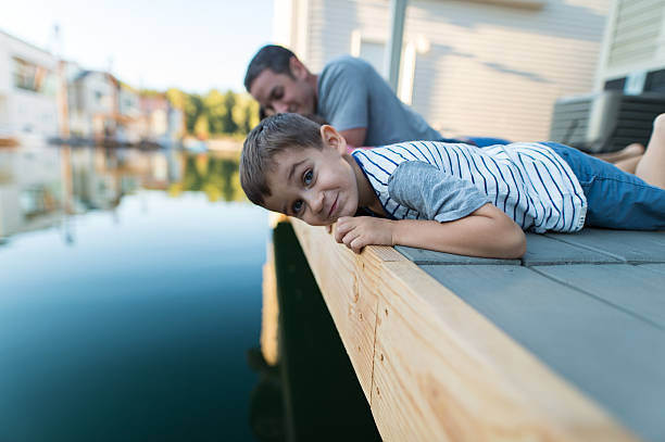 istock An adorable young boy laying on a dock spending time 637947854