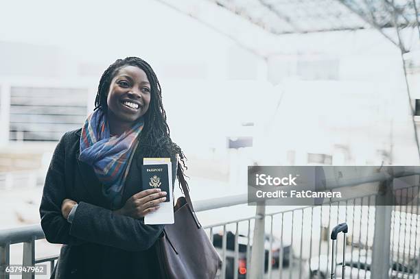 A Gorgeous Ethnic Young Adult Female Is Traveling Stock Photo - Download Image Now - Passport, Airport, African Ethnicity