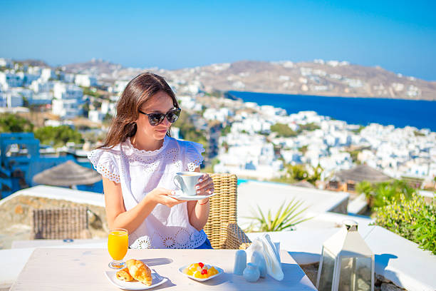 istock Beautiful elegant lady having breakfast at outdoor cafe with amazing 637948708