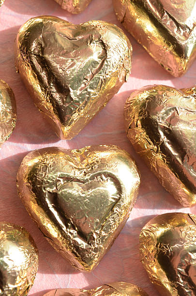 istock gold foil wrapped heart shape chocolates 637948764