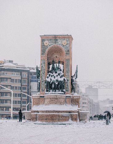 Republic Monument at Taksim Square in a snowy winter day in Beyoğlu.