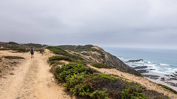 istock Portugal - Lonely hiker on path next to ocean 637950360