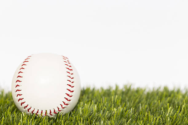 istock Baseball ball lays on a grass 637951088