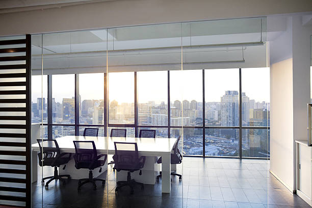 istock View of office and conference room with sunset in windows 637951802