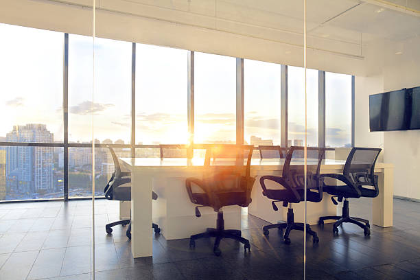 istock View of office conference room with sunset light in windows 637951840