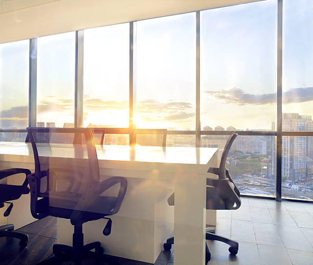istock View of office conference room with sunset light in windows 637951870
