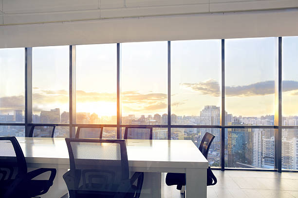 istock View of office conference room with sunset light in windows 637951924