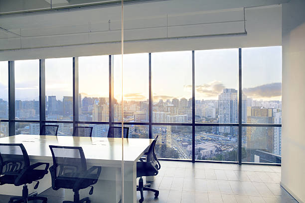 istock View of office conference room with sunset light in windows 637951948