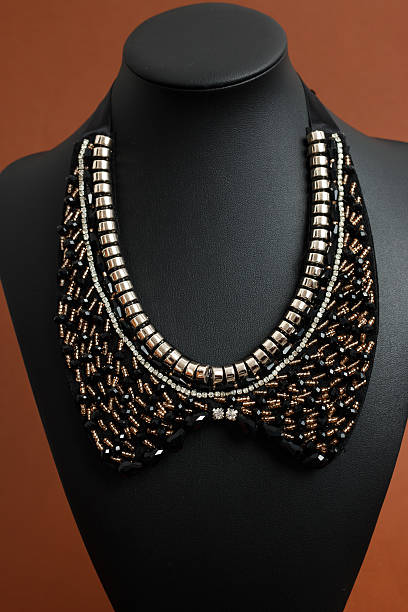 istock Woman's necklace on black leather mannequin 637952074