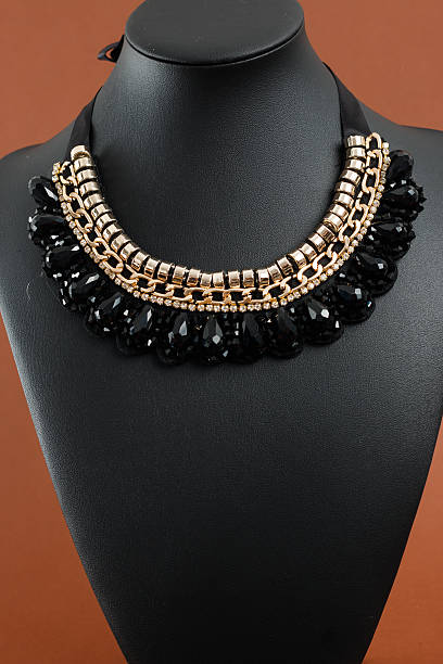 istock Woman's necklace on black leather mannequin 637952162