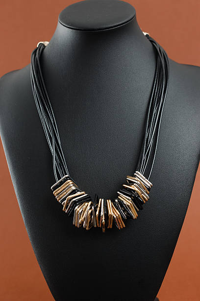 istock Woman's necklace on black leather mannequin 637952460