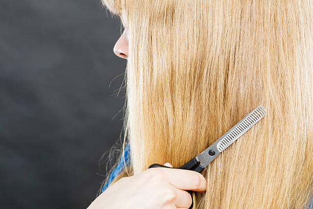 istock Blonde girl makes new hair image. 637952742