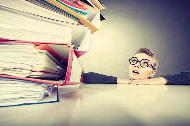 istock Accountant terrified of pils of binders. 637953416