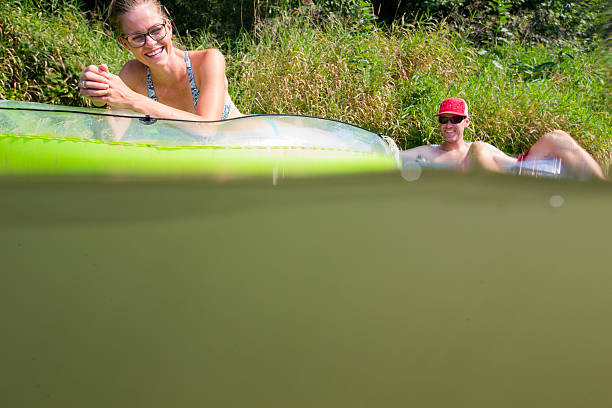 istock Couple tubing down the river in the summer 637956514