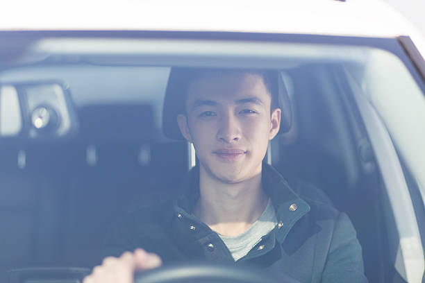 istock young asian man driver in the car 637957734
