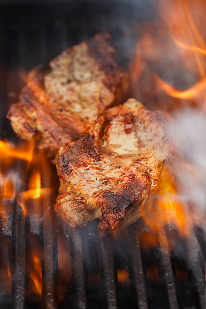 istock pork steak on bbq grill with flame 637960792
