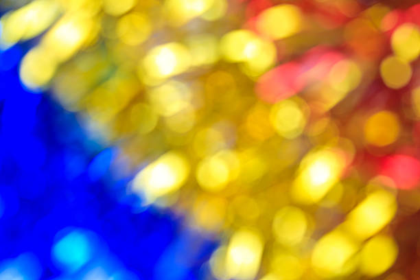 Defocused blurry focus lighting golden yellow red blue color effects background