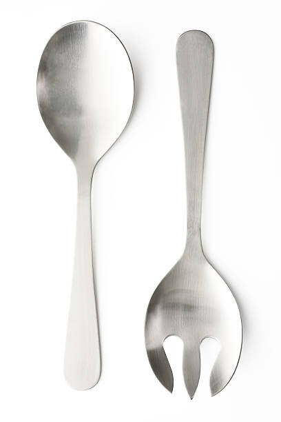 Isolated shot of silver salad servers set on white background Overhead shot of silver salad servers set, isolated on white background with clipping path. serving utensil stock pictures, royalty-free photos & images