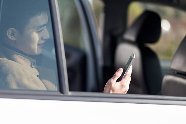istock young asian man  hold mobile phone in car 637962804
