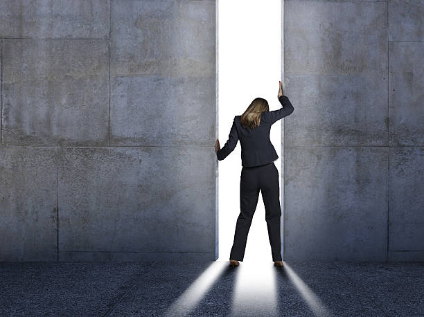 Businesswoman Pushing Open Concrete Walls