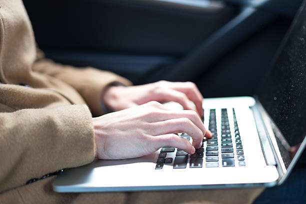 istock young asian man  using laptop in car 637965074