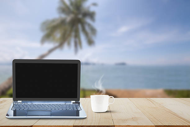 istock Computer laptop, hot coffee cup on wooden table, business concept 637968452