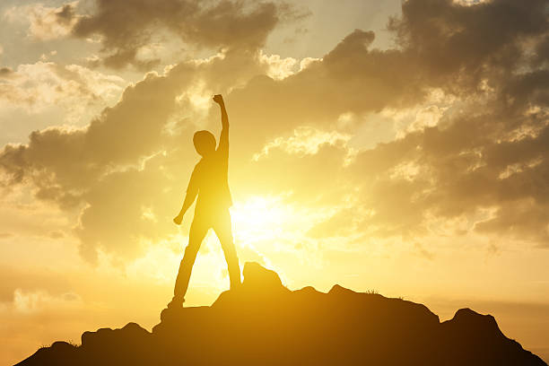 istock Man on the peak of mountain on sunset background 637969836