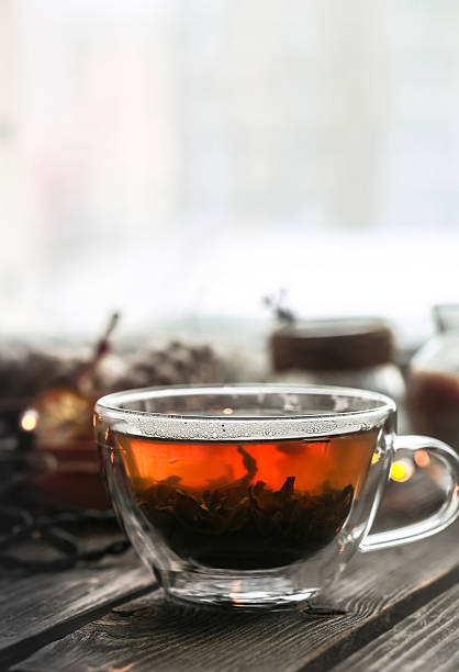 istock Transparent Cup of tea on wooden background 637974750
