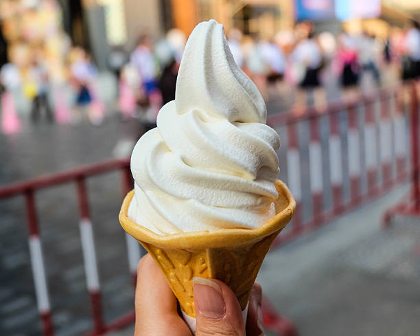 istock Ice cream cone held up in the city 637976412
