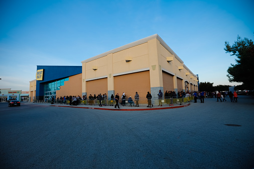 Gilroy, California, United States - November 24, 2016: Shoppers await the lines on Black Friday Sales At Best Buy. This was shot on Thanksgiving early evening for the early bird version of Black Friday. This store opened on Thursday evening since the traditional Black Friday are observed now earlier and earlier in the USA. Best Buy is a major electronics retail chain, famous for its Black Friday lines.