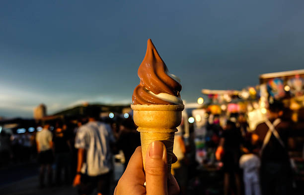 istock Ice cream cone held up in the market 637977290