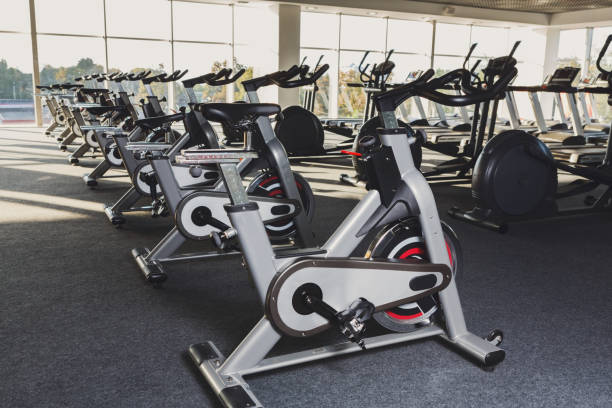 istock Modern gym interior with equipment, fitness exercise bikes 637977434