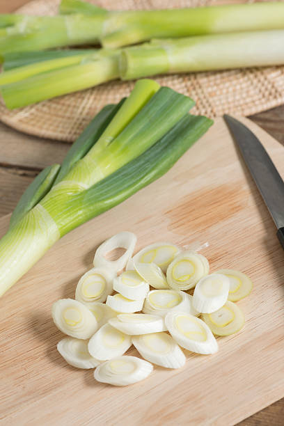 istock Fresh leeks and sliced on a wooden board. 637978028