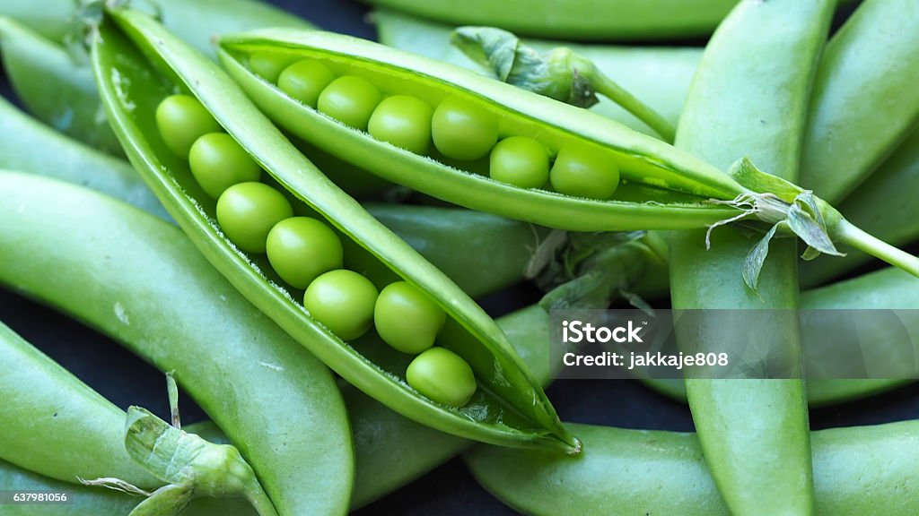 Food background Fresh green sugar snap peas on rustic wood table and vintage color process for healthy food background Green Pea Stock Photo